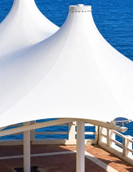 White roof with two conical peaks beside the water