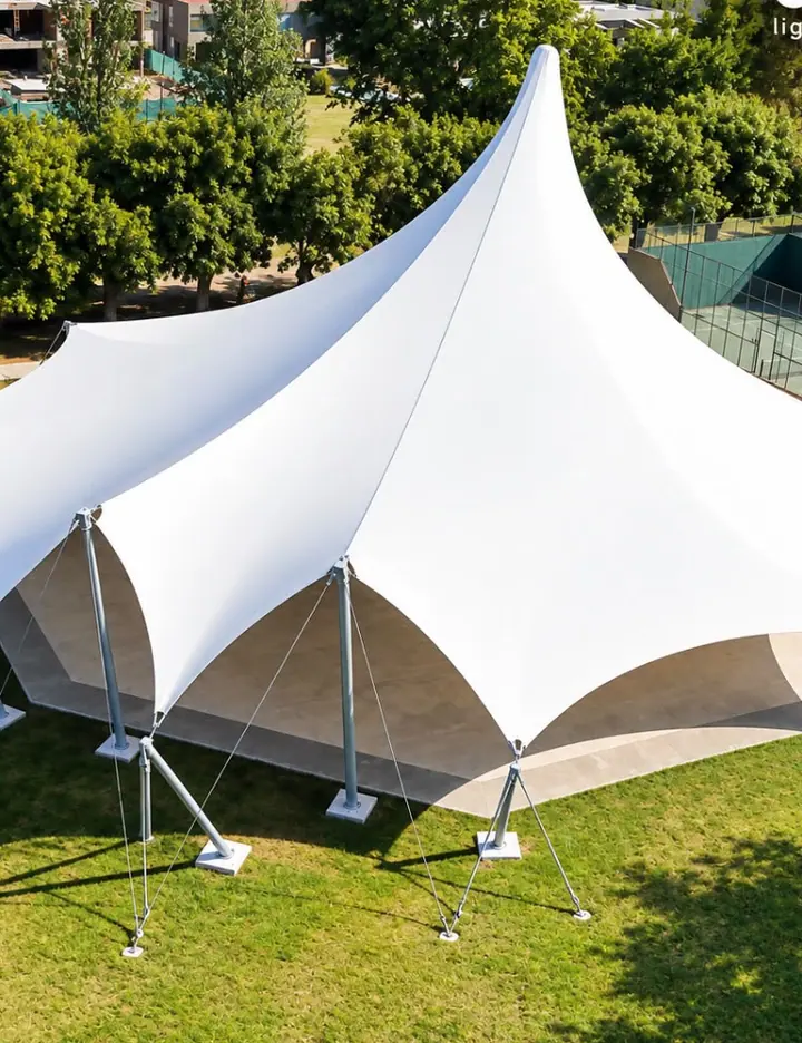 View of a twin-mast tensile canopy in a garden
