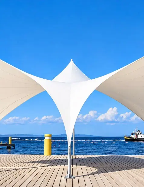 Tensile canopy beside an open space by the sea
