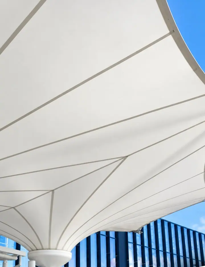 White membrane supported by a column and perimeter cables