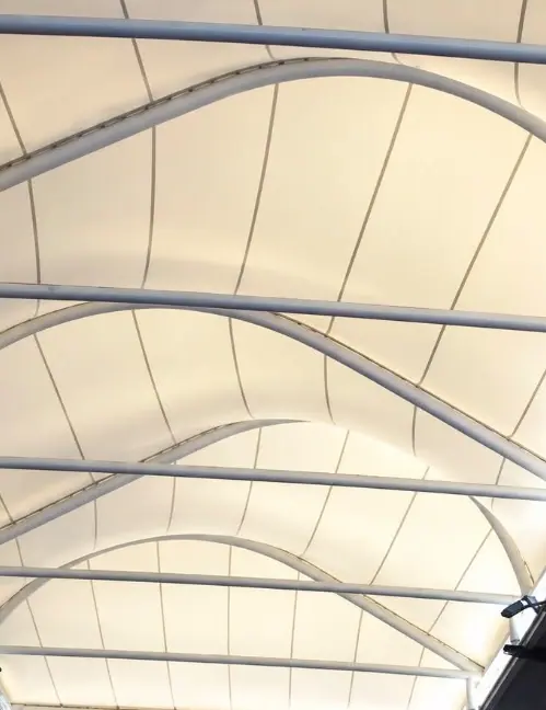 Covered walkway with steel arches and a white membrane
